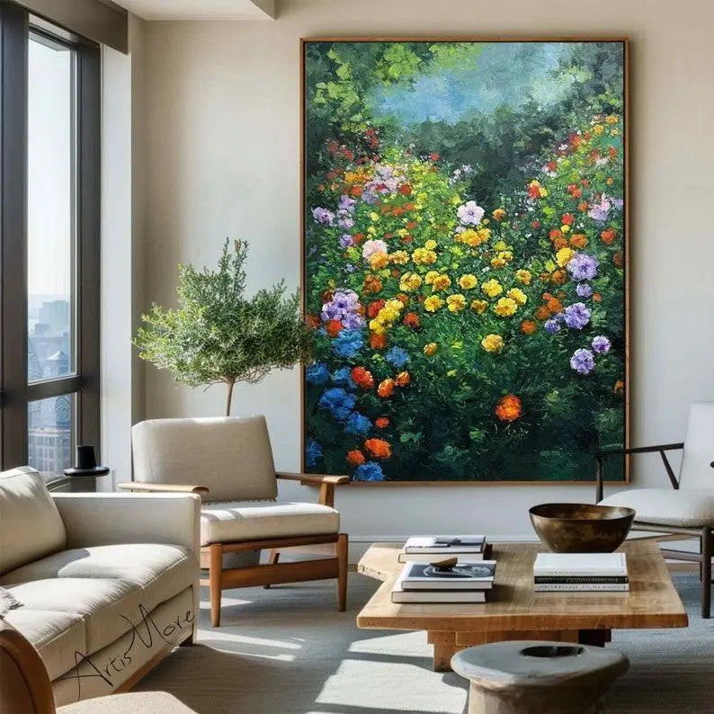 A large vertical textured wall art of colorful flowers in yellow, orange, blue and pink against lush greenery in a garden 