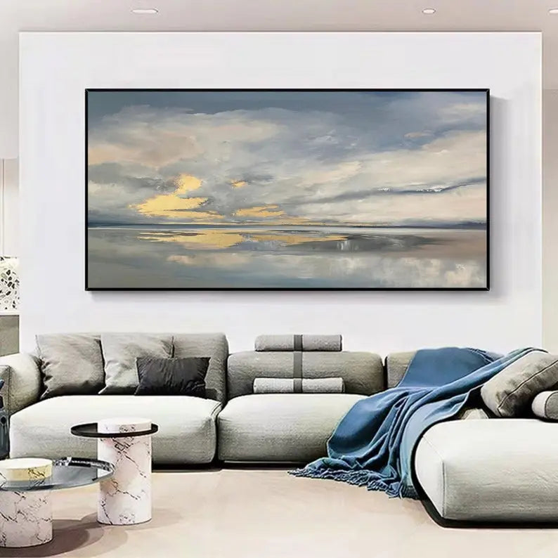 A large horizontal wall art depicting a serene grey and blue sky mirrored in calm, tranquil sea waters. 