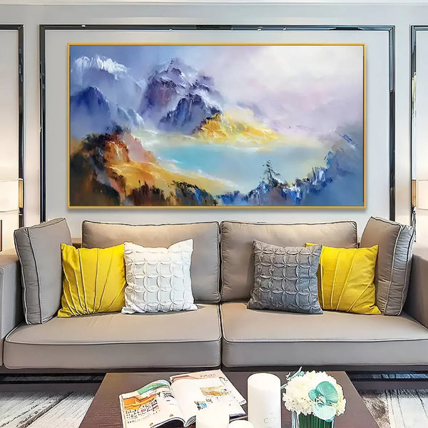 a large horizontal wall art of blue and yellow mountains surrounding a blue lake. 