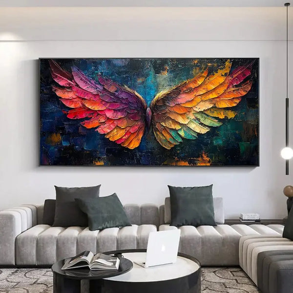A large horizontal textured plaster wall art of a pair of wings, one in pink and purple, one in orange and blue, against a backdrop of dark blue.