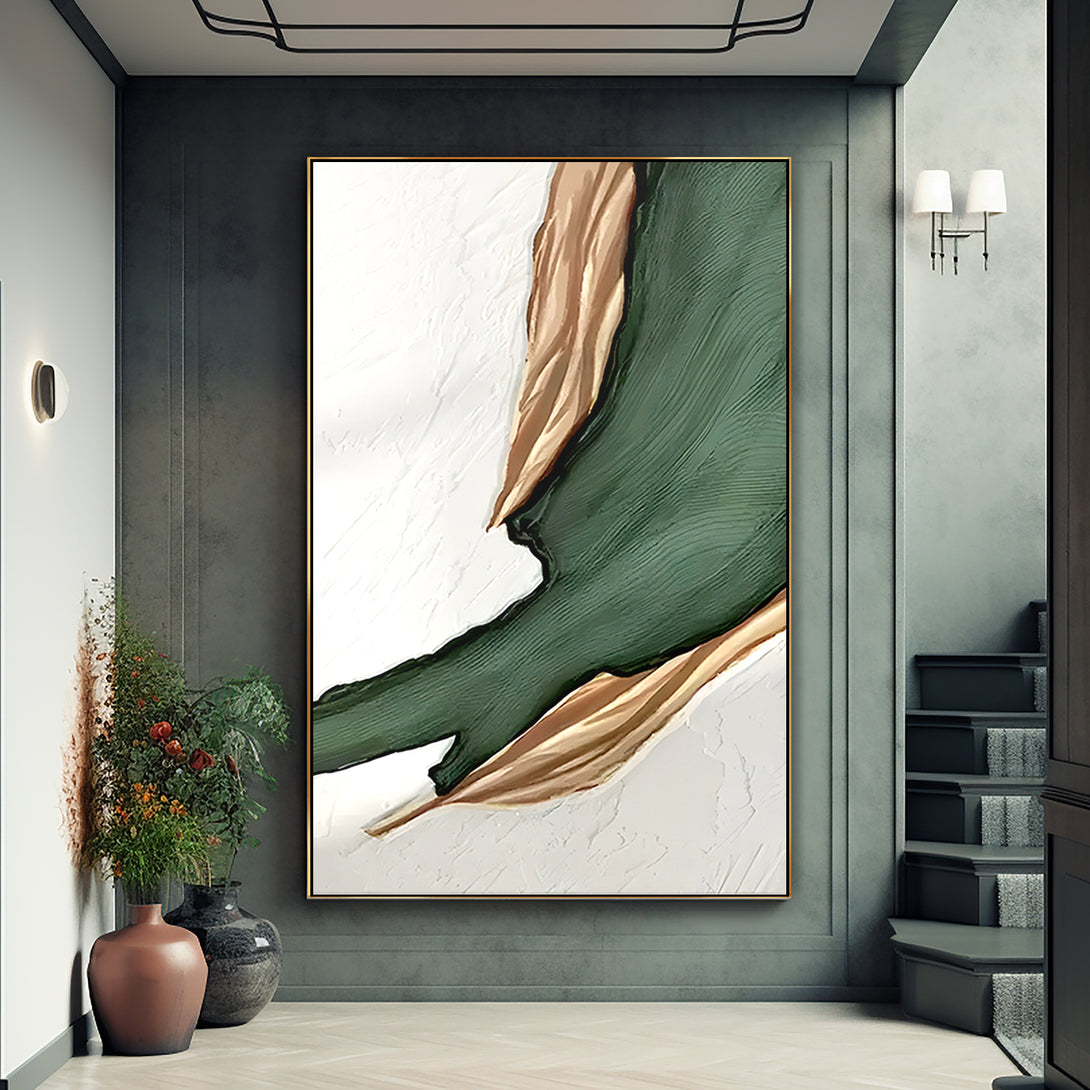 A large abstract painting with white, green and gold shades. 
