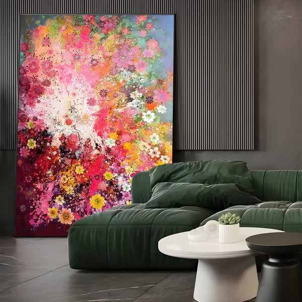 A large vertical painting full of blossoms in pink, yellow, orange and white. The center of the painting is white. 