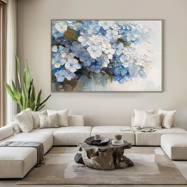 A horizontal abstract floral painting in blue and white featuring textured flowers and flowing brushstrokes across the canvas.