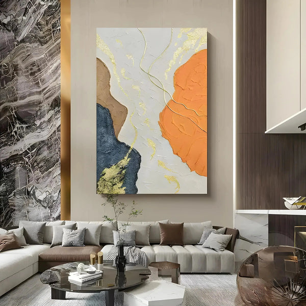 A large Wabi-Sabi wall art featuring brown, orange, blue shades and gold lines across a white canvas.  