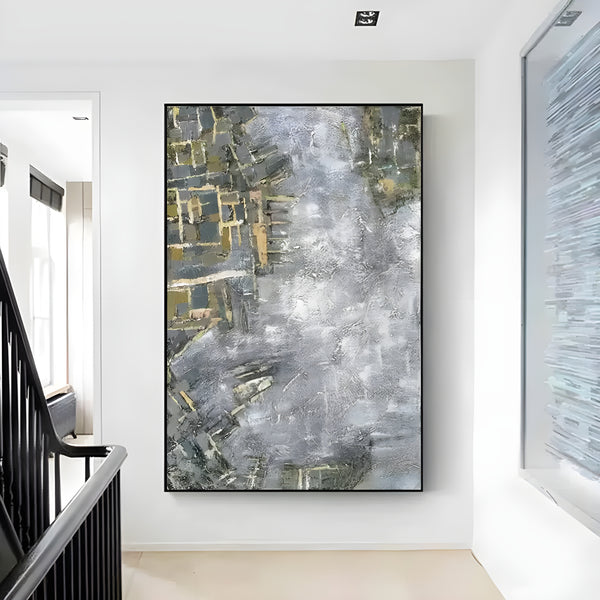 A large, colorful, abstract painting hangs above a staircase