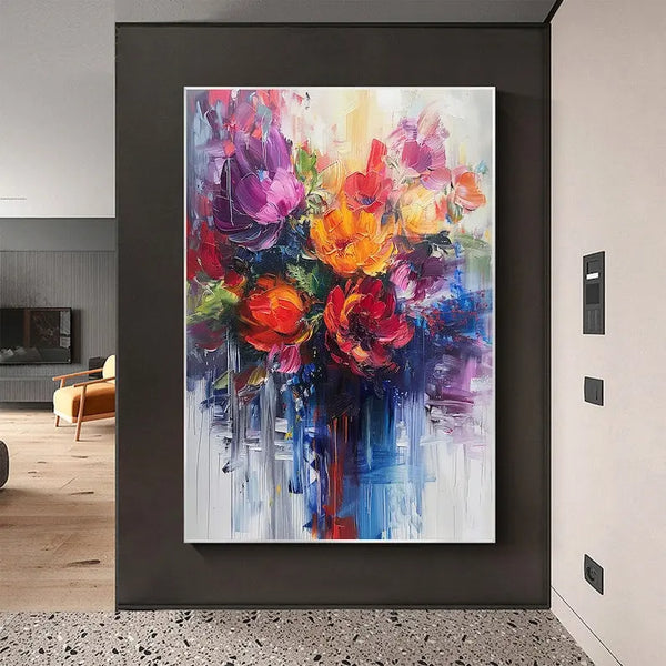 A large colorful textured painting of abstract flowers in orange and purple with green leaves 