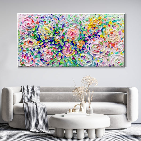 A large horizontal Bohemian colorful flower wall art featuring knife-painted flower shapes in pink, white, yellow and green.  
