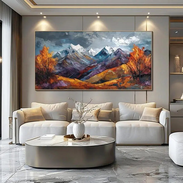 A large horizontal abstract textured painting of a mountain scene with snowy peaks, blue shadows, orange trees and vegetation, and grey skies. 