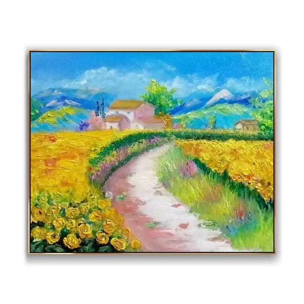 A large horizontal painting of a winding white and brown road lined with yellow flowers, leading to bungalows nestled beneath rolling mountains under a brilliant blue sky.
