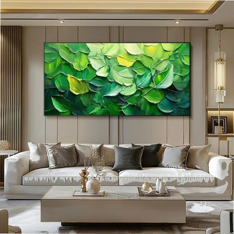 A large horizontal plaster wall art of green leaves in rich textures, including deep green, light green, and yellowish green. 