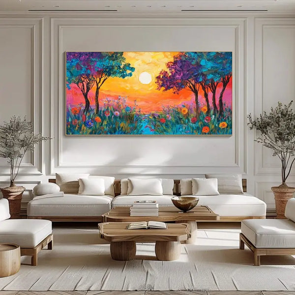 A large horizontal textured wall art of blue and purple trees and a field of color flowers, bathed in the orange sunlight. 
