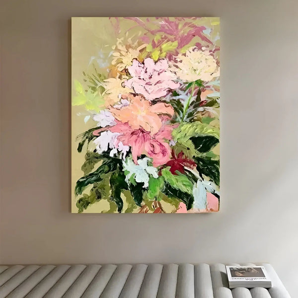 A large multi-color thick textured wall art of pink flowers with green leaves against a yellow backdrop