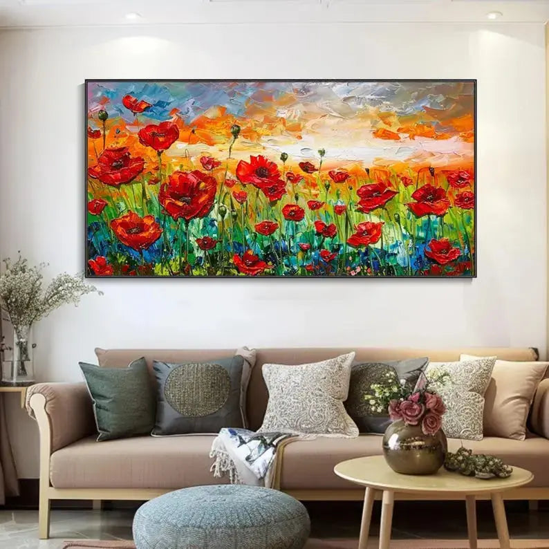 A large plastered painting of blooming orange flowers above the green grass, completed by a hue of blue, beneath the blue and orange sky. 
