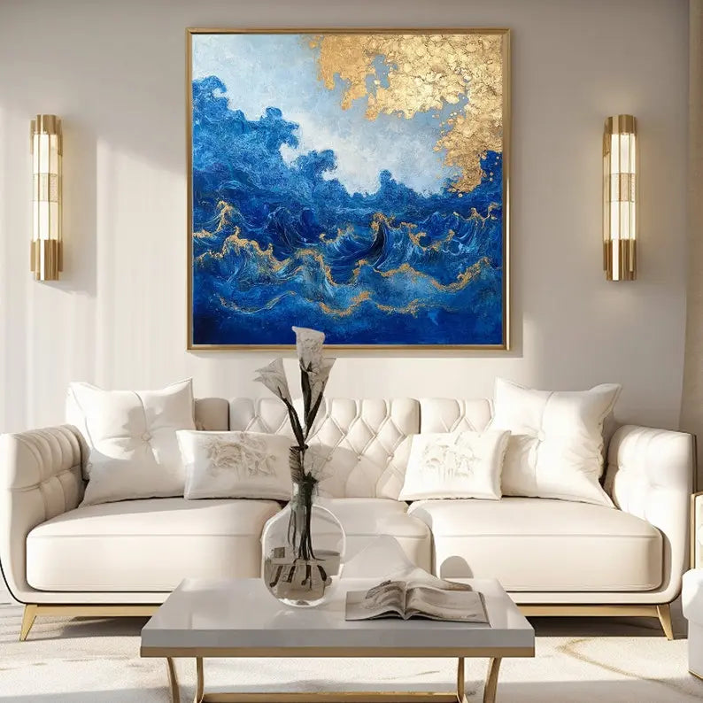 A large square painting featuring the rough blue sea waves under a tree with gold leaves. 