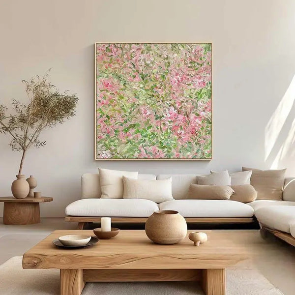 A large square textured canvas full of pink blossoms with green leaves  