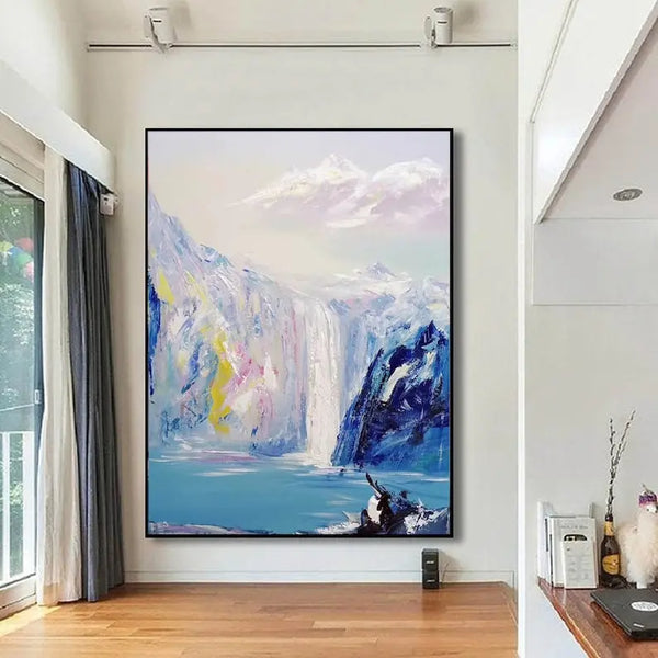 A large vertical abstract landscape painting with a waterfall in white, pink, and yellow highlights, dark blue mountains, and a small lake at the base.