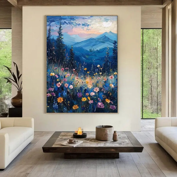 A large, vertical abstract painting featuring blue-toned flowers in the foreground with textured mountain scenery in the distance.
