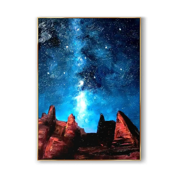 A large vertical colorful painting featuring the milky way in the starry blue night sky shining above a rugged brown rocky landscape.