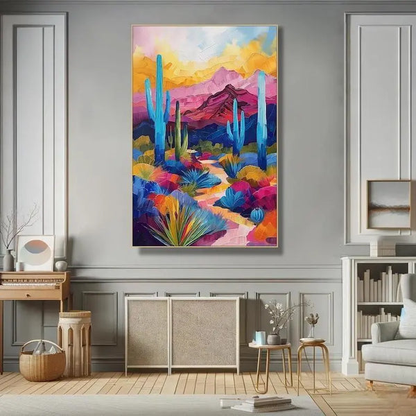  A large vertical painting of the desert with blue high-rising cacti with blue cactus flowers growing together with other plants. On the background are pink and blue mountains under the yellow and blue hued sky. 

