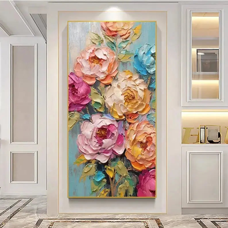  A large vertical plaster wall art featuring oversized flowers in pink, orange, and blue, accompanied by green leaves, set against a blue backdrop.
