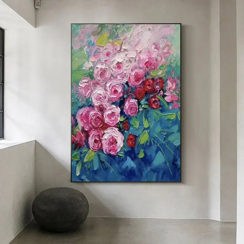 A large vertical plastered painting of blooming pink and red flowers against a blue backdrop.
