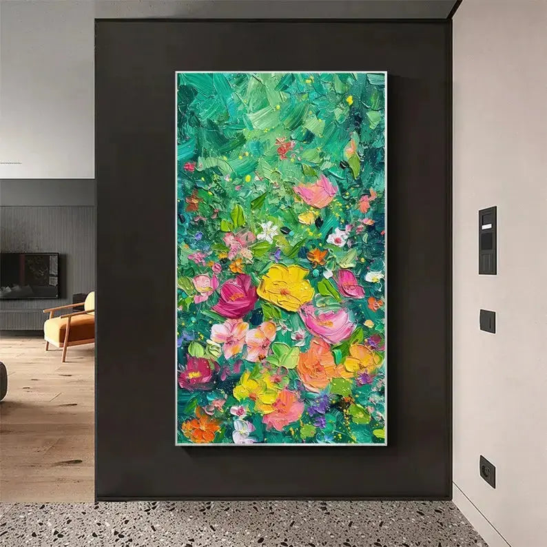 A large vertical plastered painting of flowers in a variety of colors including yellow, pink, orange and purple against a green backdrop.

