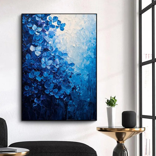 A large vertical textured painting of blue flowers. 
