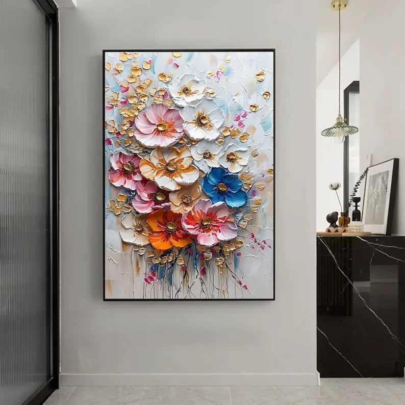 A large vertical textured painting of flowers in pink, white, blue and orange layers of acrylics, accented by small gold blossoms, against a blue and white backdrop. 