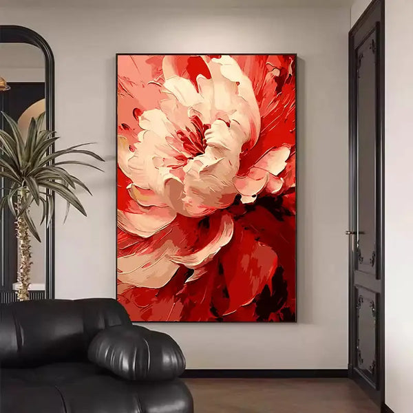 A large vertical wall art of a white plaster flower against a red backdrop. 
