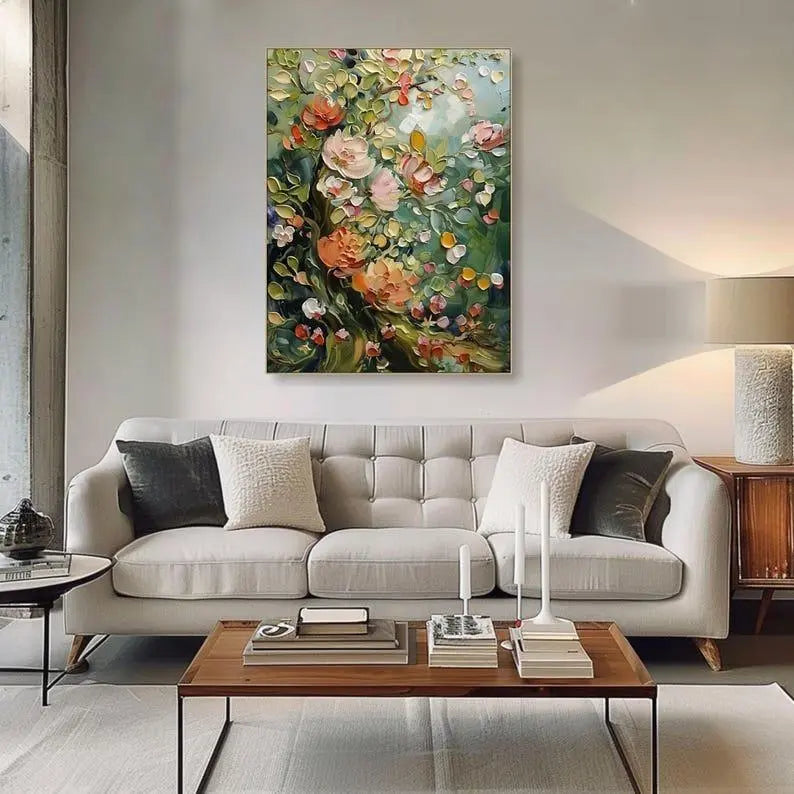 A large vertical wall art of textured flowers in pink and orange with green leaves, against a green backdrop. 