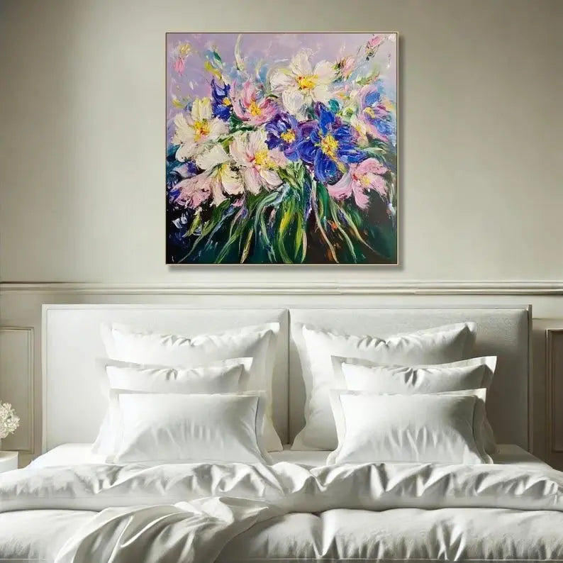 A square abstract flower painting with textured layers of purple, blue, cream, pink, and yellow petals surrounded by green foliage on a scenic canvas background.