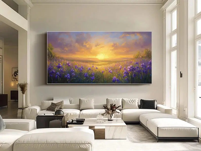 A textured horizontal wall art featuring an expansive field of purple flowers amidst green grass, beneath the sunset-lit sky with light purple clouds. 

