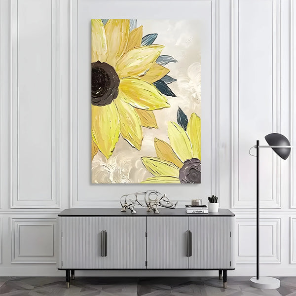 A textured vertical wall art of two sunflowers with large delicate petals on the white and beige canvas. 
