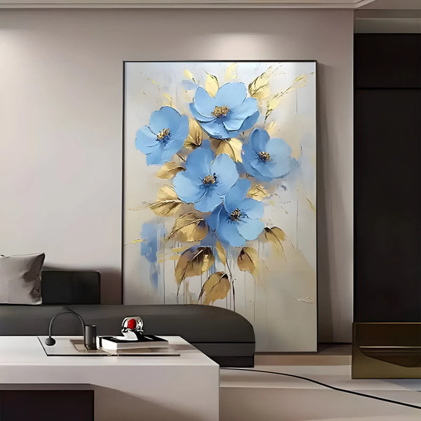  A vertical abstract flower painting with bold blue petals and flowing gold accents layered in thick, dimensional texture.