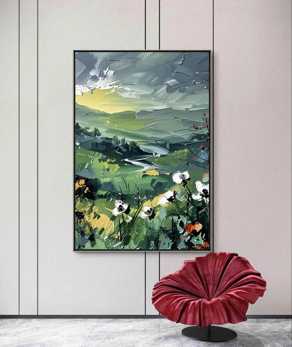  A vertical textured wall art of nature scenery such as the flowing river, green trees, hills with white flowers, green plains on the horizon. 
