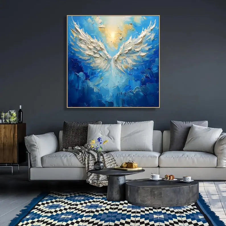 Abstract painting of large white angel wings set against rich blue skies, with a golden sun symbolizing the angel's head in mid-flight.