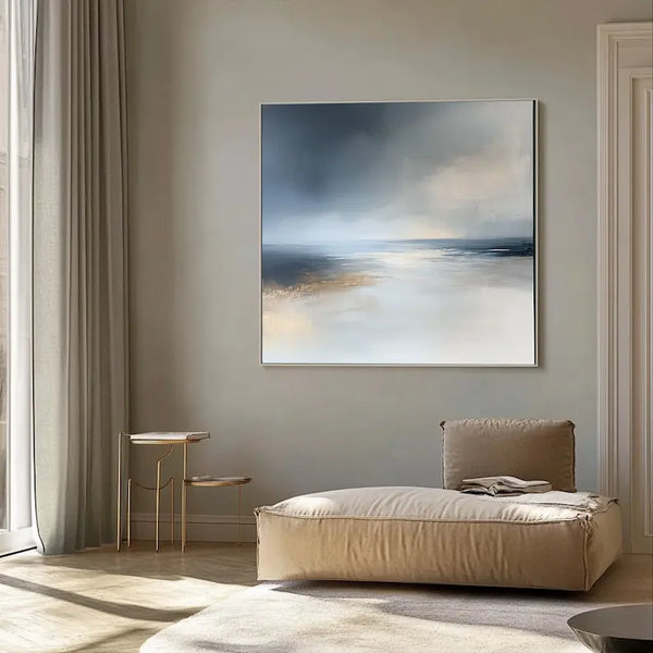 An abstract square canvas painting in blue and grey tones depicting a minimalist ocean and skyline by Adi Cheng.
