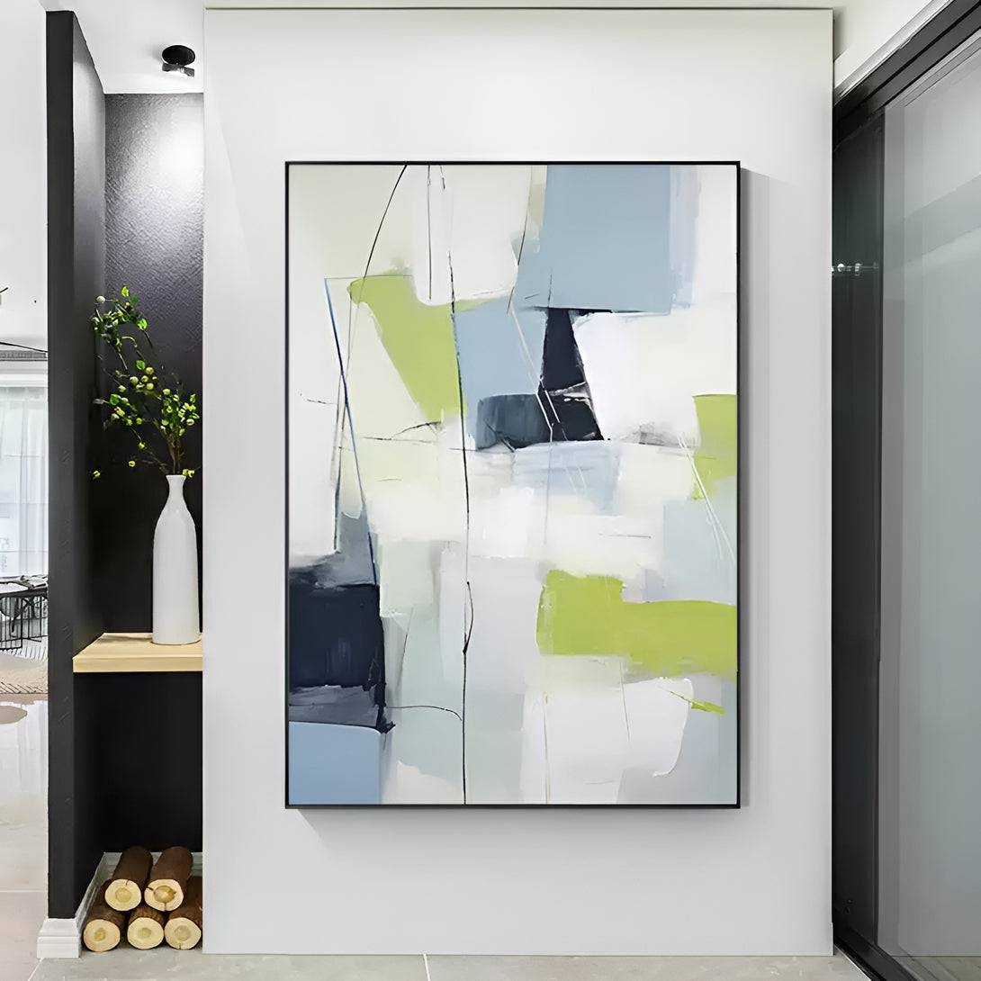 A large long abstract canvas wall art mixing blue, green and white hues. 