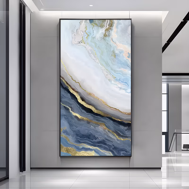 a tall vertical abstract painting of marbled blue and white flow on a diagonal, pale cream and aqua above, slate blue below, with gold veins tracing the seam, in smooth blended paint and gold leaf