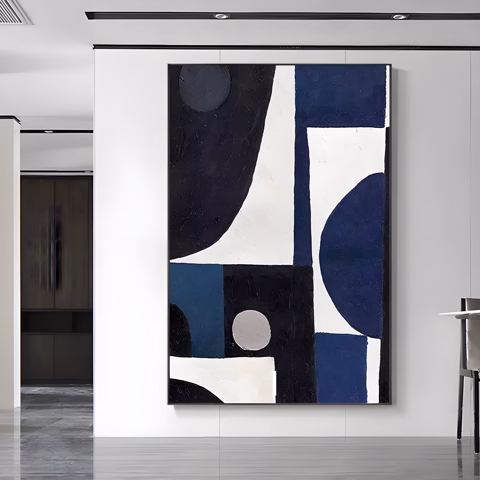 a large vertical geometric abstract painting of navy, black, cream and teal blocks and half-circles fitted together like a puzzle, with a small pale gray disc at the lower center, in matte textured paint
