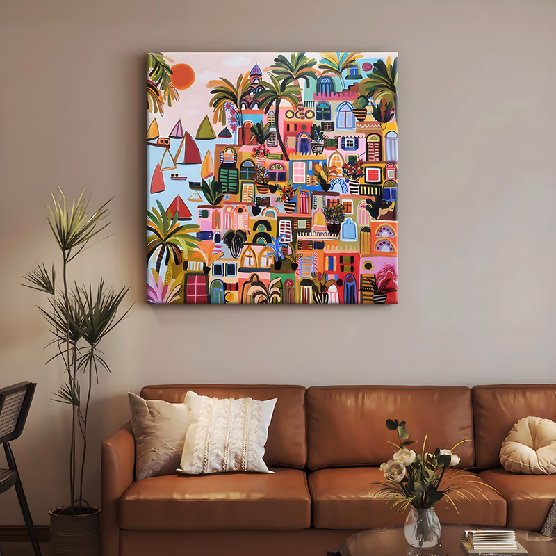 a large square folk-style painting of a hillside town built from stacked pastel houses in pink, yellow and mint, green palm trees between them, small red and green sailboats at left under an orange sun, in flat acrylic