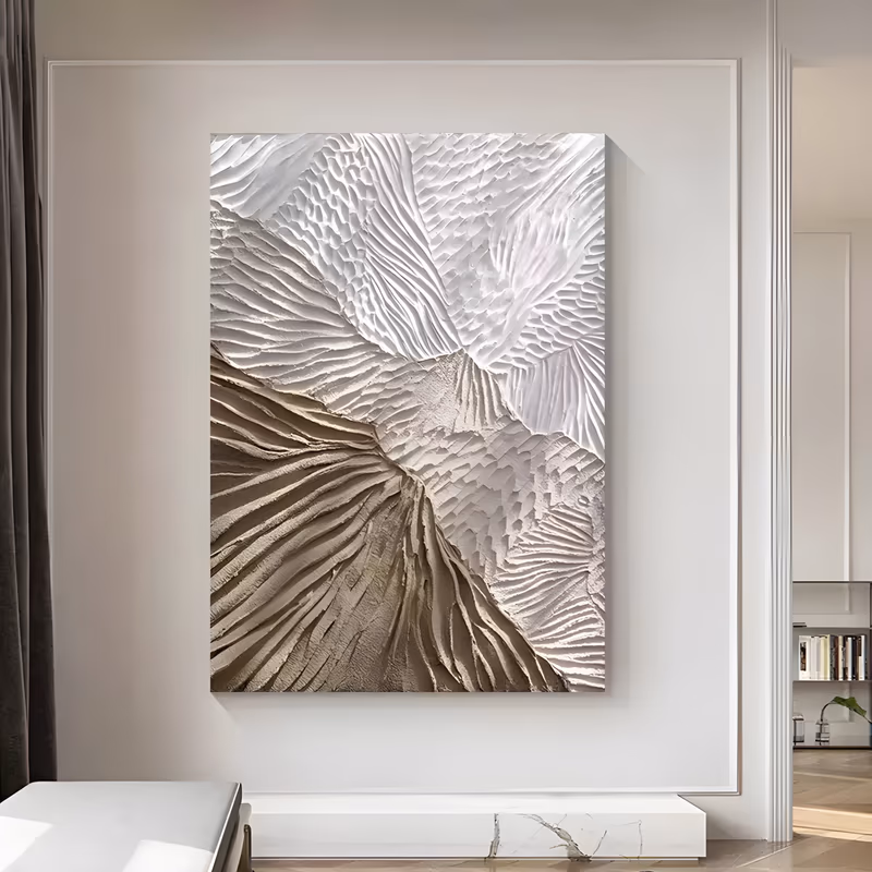 a large vertical textured wall art panel of radiating combed plaster ridges, white ripples in the upper half fanning down into a warm taupe and beige sunburst of raised lines, in heavy sculpted relief