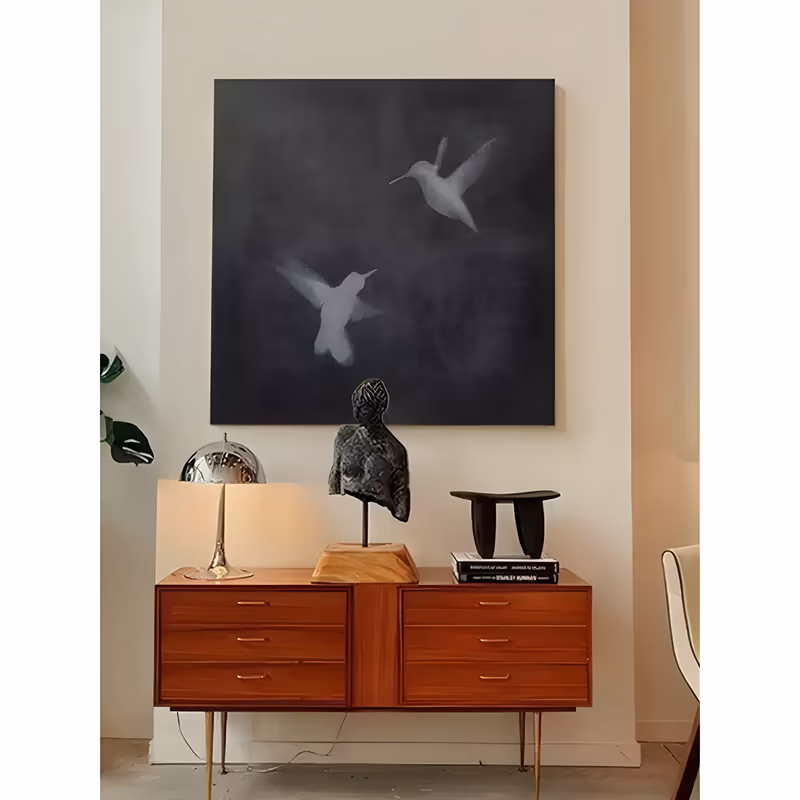 a large square minimalist painting of two pale gray hummingbirds in flight in the upper half of a smoky dark charcoal ground, their wings blurred at the edges, in softly blended acrylic