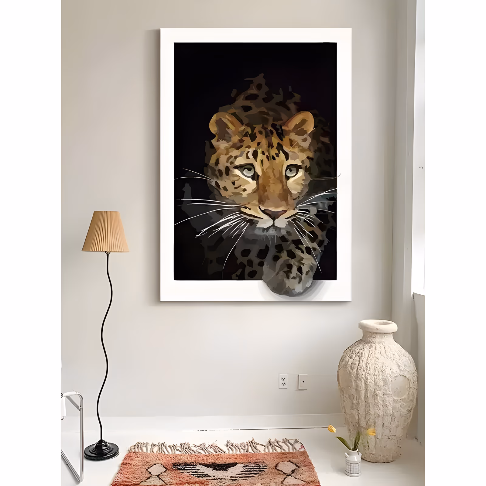a large vertical animal painting of a leopard's head and one front paw emerging from a solid black background, its tan and gold coat marked with dark rosettes and long white whiskers, in flat matte acrylic