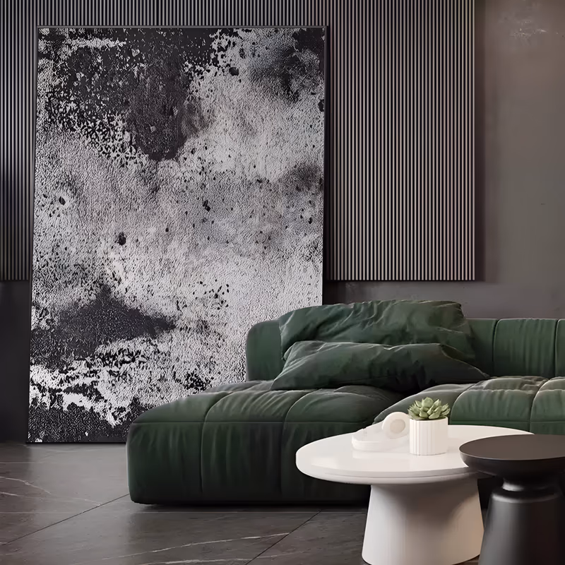 a large vertical textured abstract painting of mottled black and white paint pitted like weathered stone, with dark clouded patches at the top and a pale chalky field below, in gritty heavy impasto
