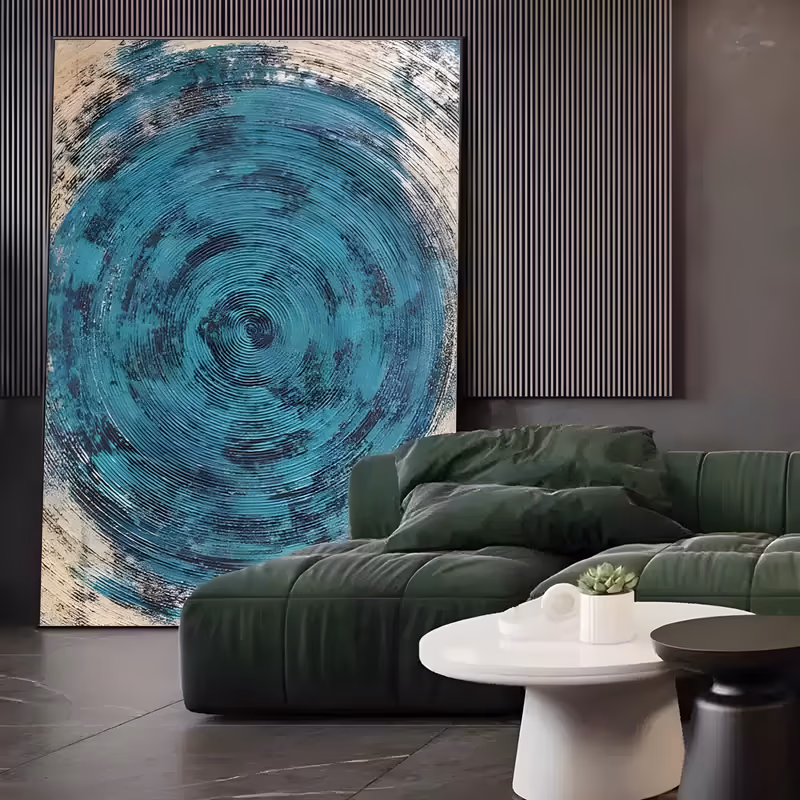 a large vertical abstract painting of one teal concentric circle ringed with fine raised grooves, spiraling out from a dark center onto a scratched beige and black border, in thick sculpted acrylic