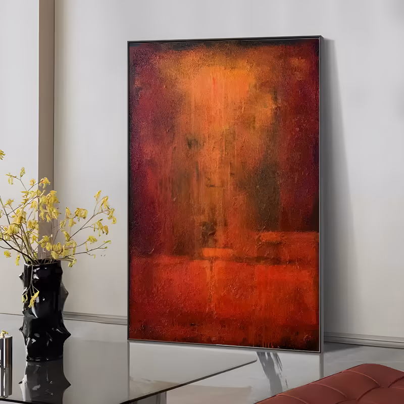 a large vertical abstract color field painting glowing orange at the center and darkening to crimson and near-black at the edges, its surface grainy and scraped with faint vertical drips, in layered oil