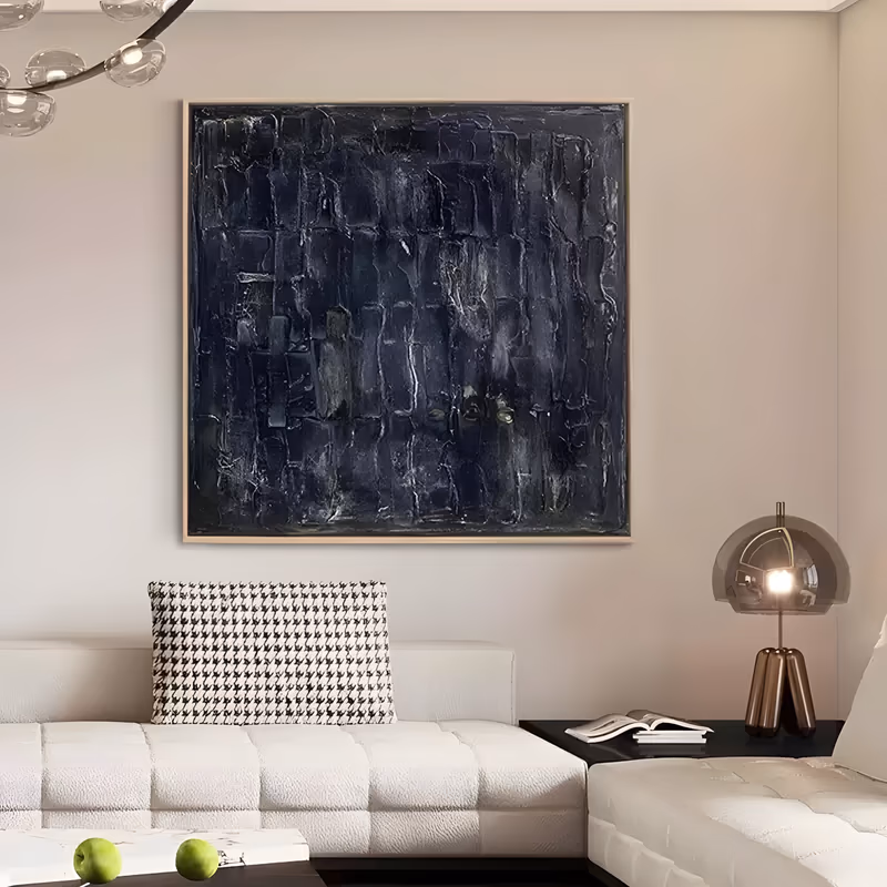 a large square textured abstract painting of a dark navy surface built from vertical block strokes, with faint gray ridges, pale scratches and two yellow-green flecks at lower center, in thick knife-applied paint