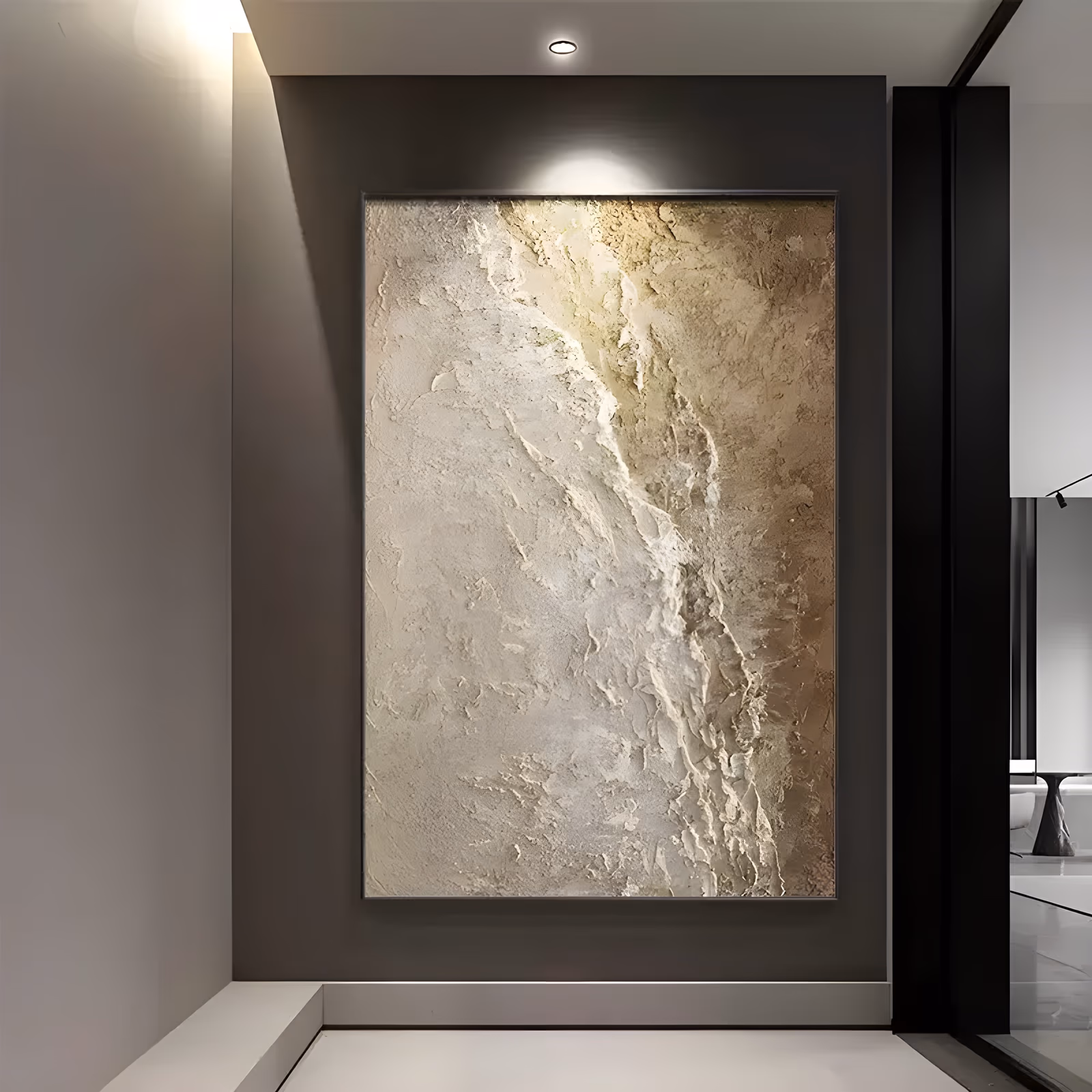 a large vertical textured painting of a craggy ridge built in thick cream and sand plaster, a raised diagonal spine running from the top right down through the center and catching light in gold, in sculpted relief