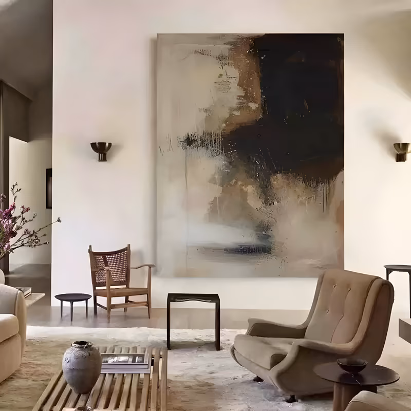 a large vertical abstract painting of a scraped mass of earth brown and near-black paint pressed over the upper right of a pale greige ground, with drips and combed marks, in dragged palette-knife acrylic